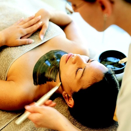 A Young Woman Taking Facial Detoxification By A Pro-Massage Therapist In A leading Massage Center.